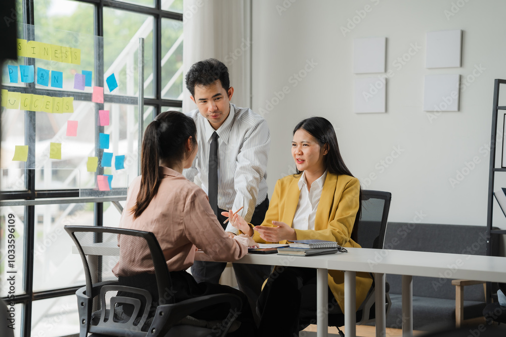 Strategic Collaboration: A focused team meeting in a modern office setting. The image captures the essence of brainstorming, idea generation, and collaboration. The bright.