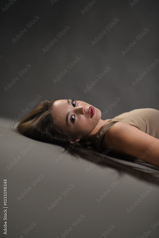 Beautiful girl posing on a gray background. Beauty and fashion. Beautiful girl posing on a gray background. Beauty and fashion.