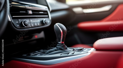 Close-up of modern car interior featuring sleek gear shift and luxurious red leather seating, showcasing automotive design excellence. photo