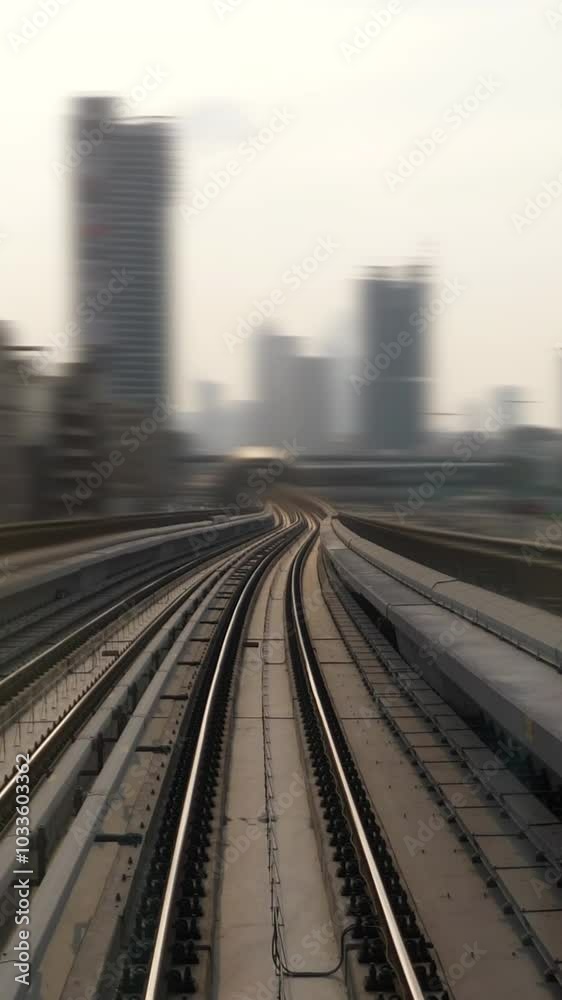 An artistic depiction of curved train tracks weaving through an urban landscape setting An artistic depiction of curved train tracks weaving through an urban landscape setting