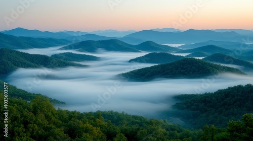 Serene mountain landscape shrouded in mist during sunrise, showcasing nature's beauty.