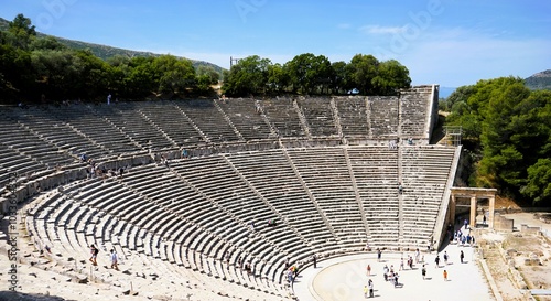 Panoramic view on a sunny summer day over the Ancient Theatre of Epidaurus in Greece, dedicated to the ancient Greek God of medicine, Asclepius. Holidays and sightseeing in Greece