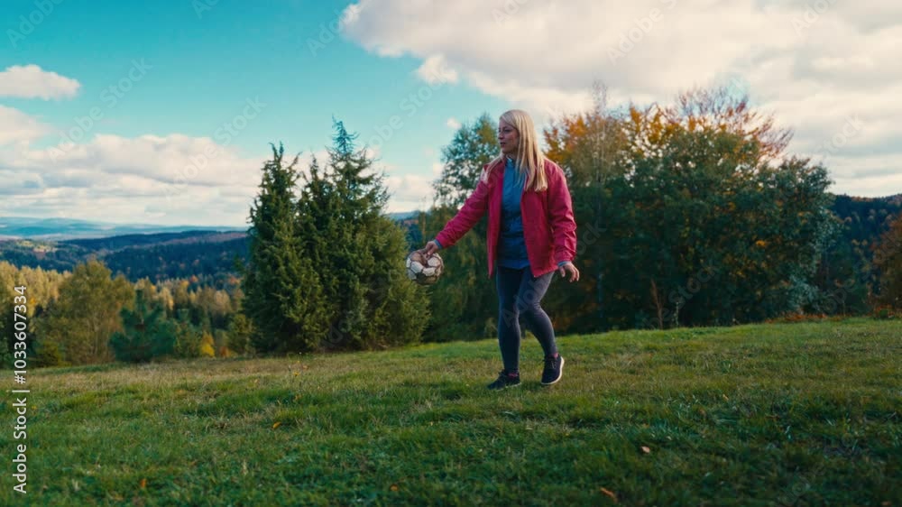 Woman plays fetch with a ball with her dog on a mountain meadow, surrounded by lush greenery. Concept of outdoor activity, companionship, and enjoyment in nature Woman plays fetch with a ball with her dog on a mountain meadow, surrounded by lush greenery. Concept of outdoor activity, companionship, and enjoyment in nature