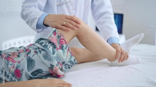 Doctor and kid patient. Orthopedist examining girl's knee in medical clinic. Medicine and health care photo