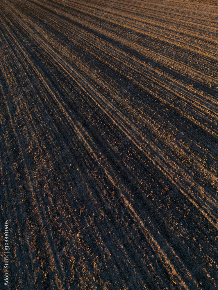 View above plowed field in autumn, ready for sowing. Agricultural landscape. Arable land ready for sowing crops. View above plowed field in autumn, ready for sowing. Agricultural landscape. Arable land ready for sowing crops.