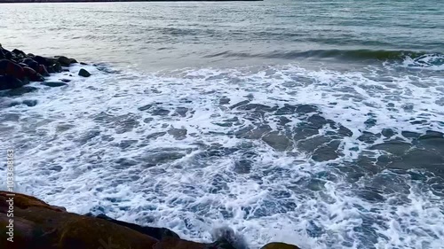 Stunning ocean waves, rocky shores, side view. Seascape, tranquil resting place, Waves caress the beauty of the seashore