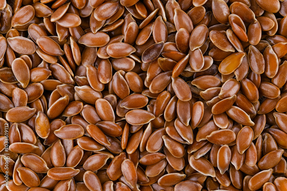 Background of brown flax seeds. Very close macro photography. Top view. Completely in focus. Background of brown flax seeds. Very close macro photography. Top view. Completely in focus.