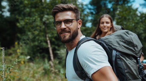 A pair of hikers with backpacks move through a lush green forest, embracing adventure and exploration as they immerse themselves in the serene natural surroundings.