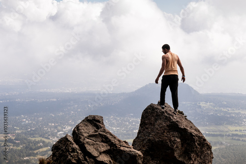 Man stands triumphantly atop Cumbres del Ajusco photo