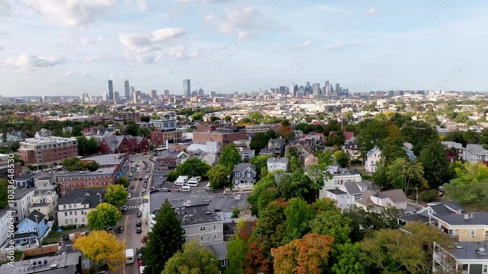 aerial pullout over Boston Massachusetts homes and neighborhoods with skyline in background