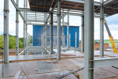 Construction of a metal frame multi-story industrial building. Floor beams.