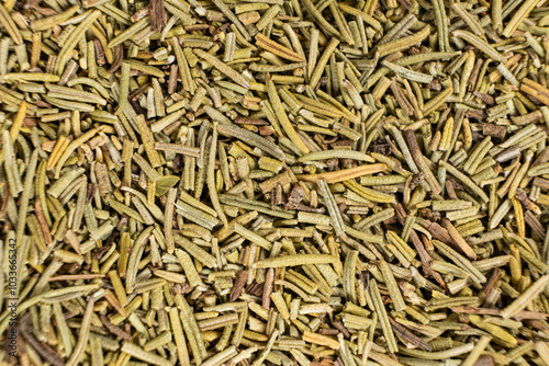 Background macro dried rosemary leaves top view, seasoning texture.