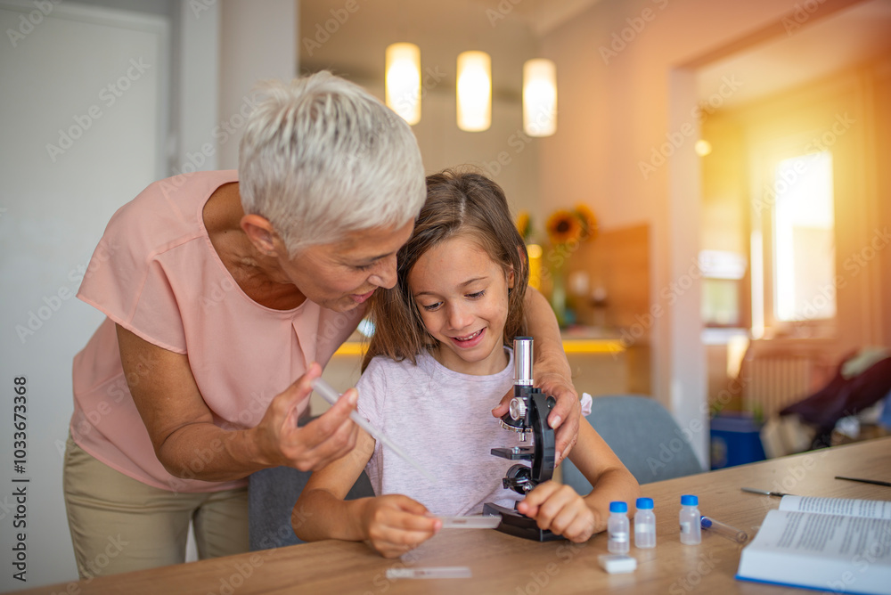 © Dragana Gordic - Grandmother and Granddaughter Exploring Science with Microscope