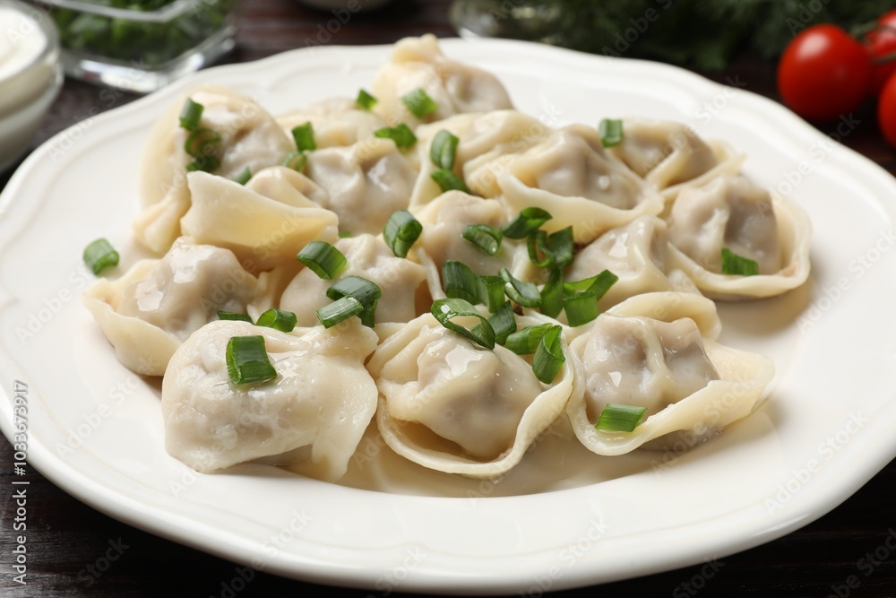 Delicious pelmeni with green onion on table, closeup Delicious pelmeni with green onion on table, closeup