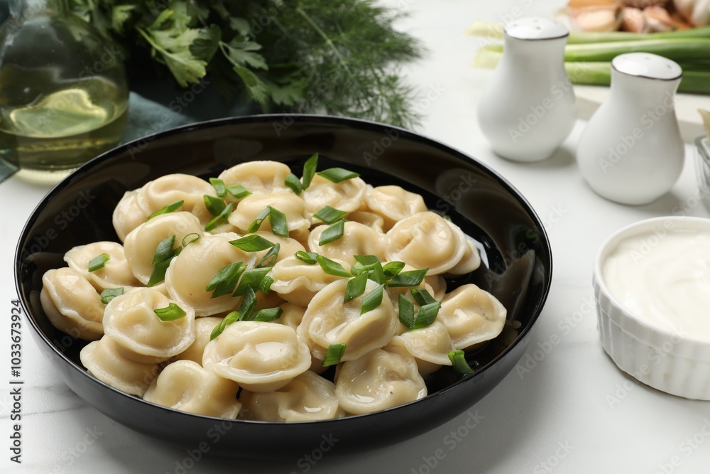 Delicious pelmeni with green onion served on light table, closeup Delicious pelmeni with green onion served on light table, closeup