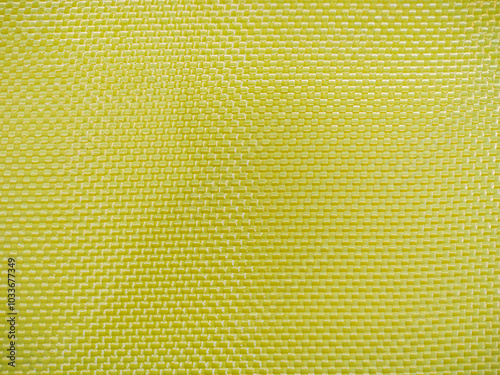 Bulletproof material aramid. Yellow kevlar texture and pattern. photo