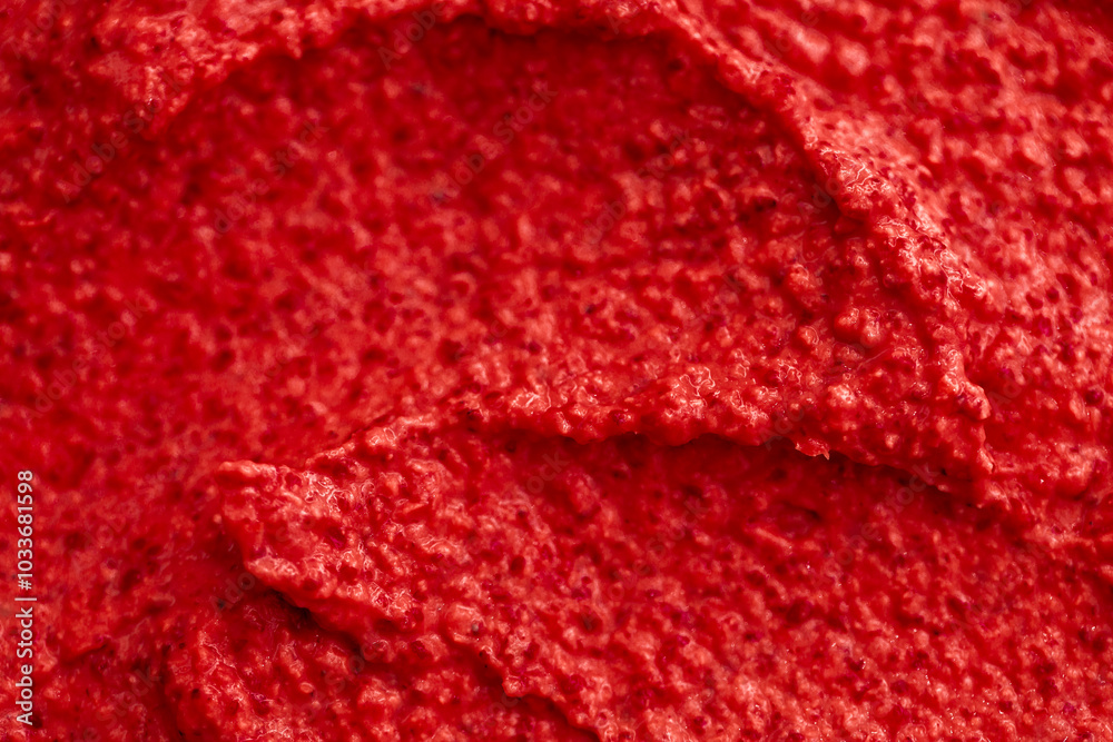 Red berry yogurt ice cream. Fresh fruit smoothie with strawberries, raspberries, pomegranate and red currants. Ice cream texture. Delicious sweet dessert close-up as a background.