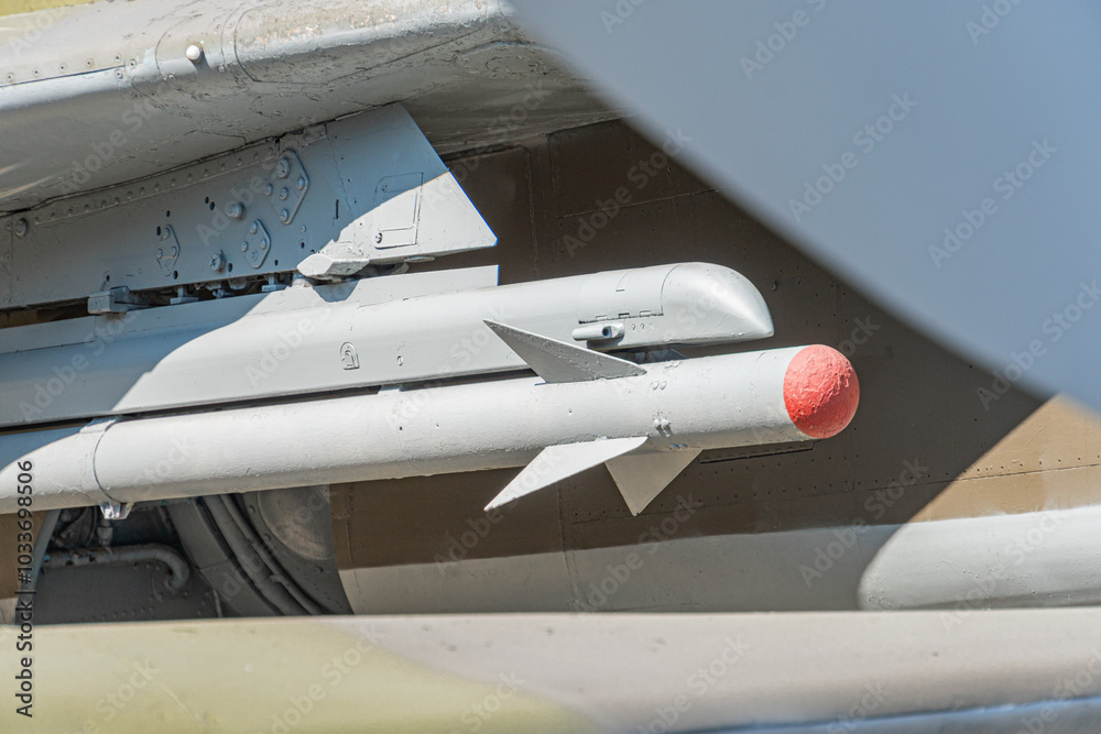 Close-up view of Ukrainian Air to air missile hanging under the wing of fighter aircraft. Soft focus. Military industry theme. airplane rocket Close-up view of Ukrainian Air to air missile hanging under the wing of fighter aircraft. Soft focus. Military industry theme. airplane rocket
