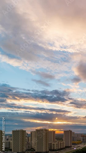 Vertical video. Ekaterinburg, Russia. A colorful sunset turns into night. Then the morning comes. Residential buildings in a new area of the city. Akademicheskiy District, TimeLapse photo