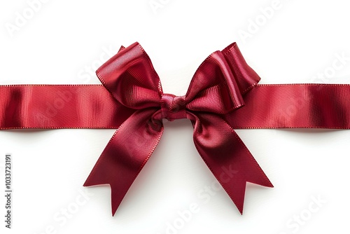 A red ribbon tied to a bow on a white surface