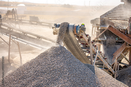 Crushing stones in a quarry for processing minerals, cement, limestone. Distribution and Screening Plant Gravel. Vibrating screen stone crusher in operation. photo