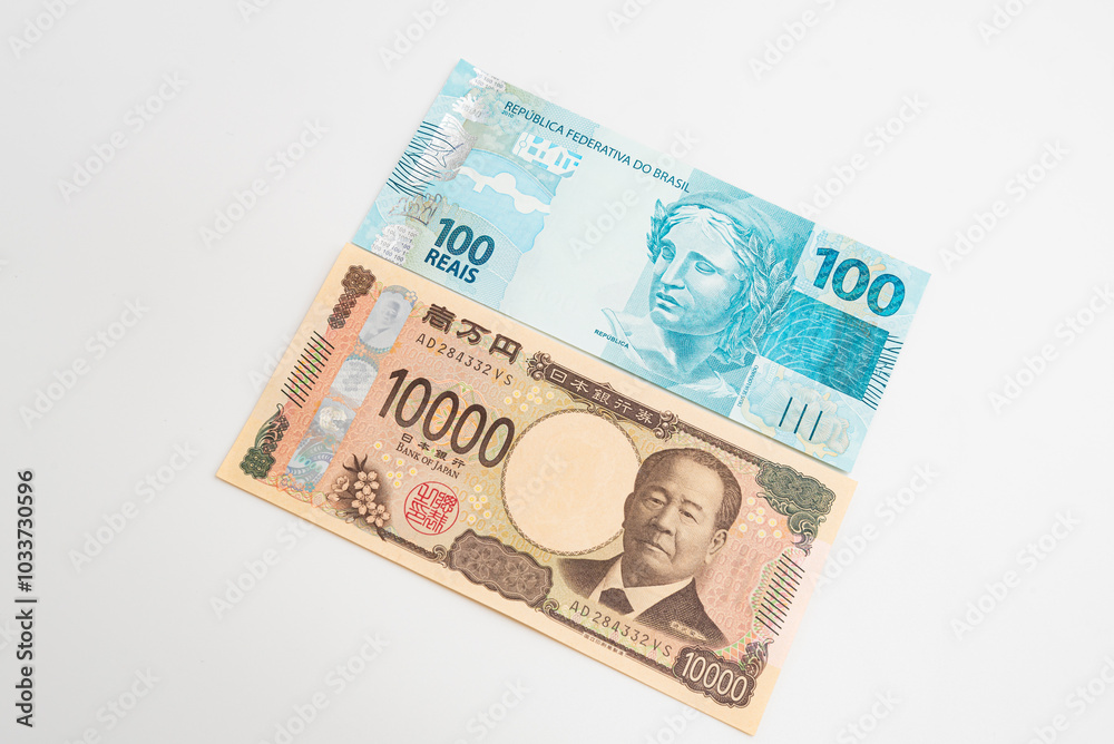 10 thousand Japanese yen and one hundred Brazilian reais isolated on white background 10 thousand Japanese yen and one hundred Brazilian reais isolated on white background