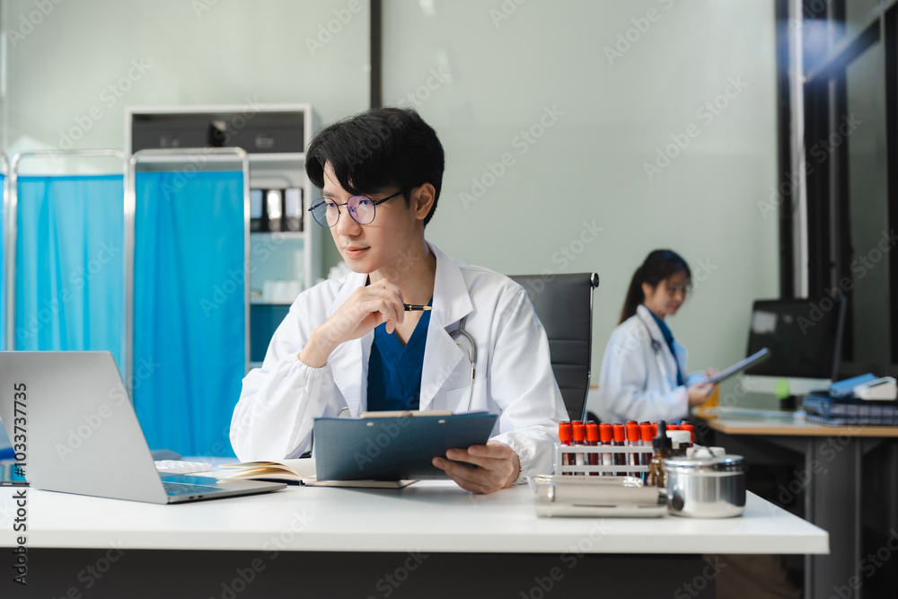 Medical Technology Concepts. The doctor is working on a tablet digital tablet computer in office in the morning at the desk. Medical Technology Concepts. The doctor is working on a tablet digital tablet computer in office in the morning at the desk.