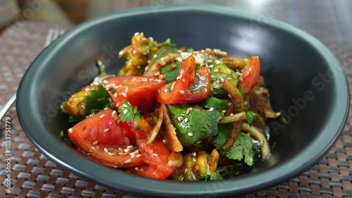 salad of ofaschi, pepper, greens. Garnished with sesame seeds and sauce