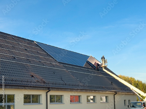 Installation of solar panels on the roof of a newly built retail store roof.
