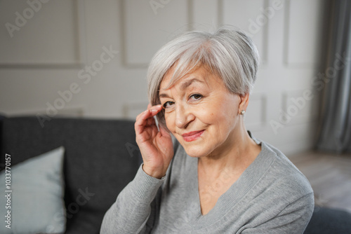 Portrait of confident stylish european middle aged senior woman. Older mature 60s lady smiling at home. Happy attractive senior female looking camera close up face headshot portrait. Happy people