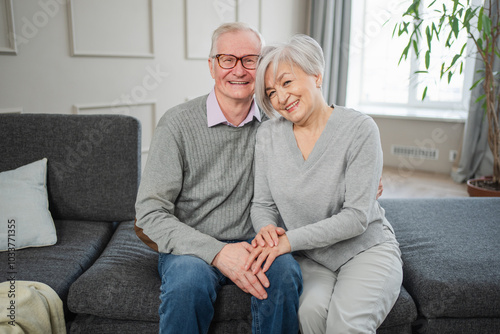 Senior adult mature couple hugging at home. Mid age old husband and wife embracing with tenderness love enjoying sweet bonding wellbeing. Grandmother grandfather together. Family moment love and care