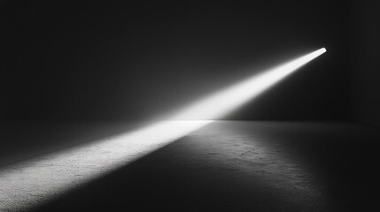 A black and white photo of a room with a light shining on the floor