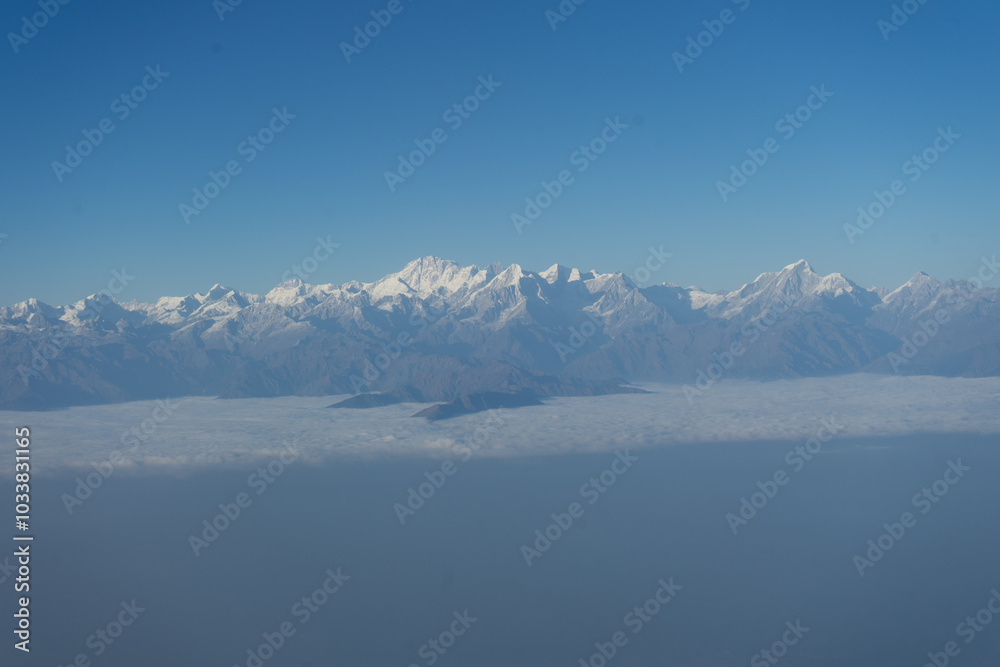 A breathtaking view of snow-capped mountains under a clear blue sky. A breathtaking view of snow-capped mountains under a clear blue sky.