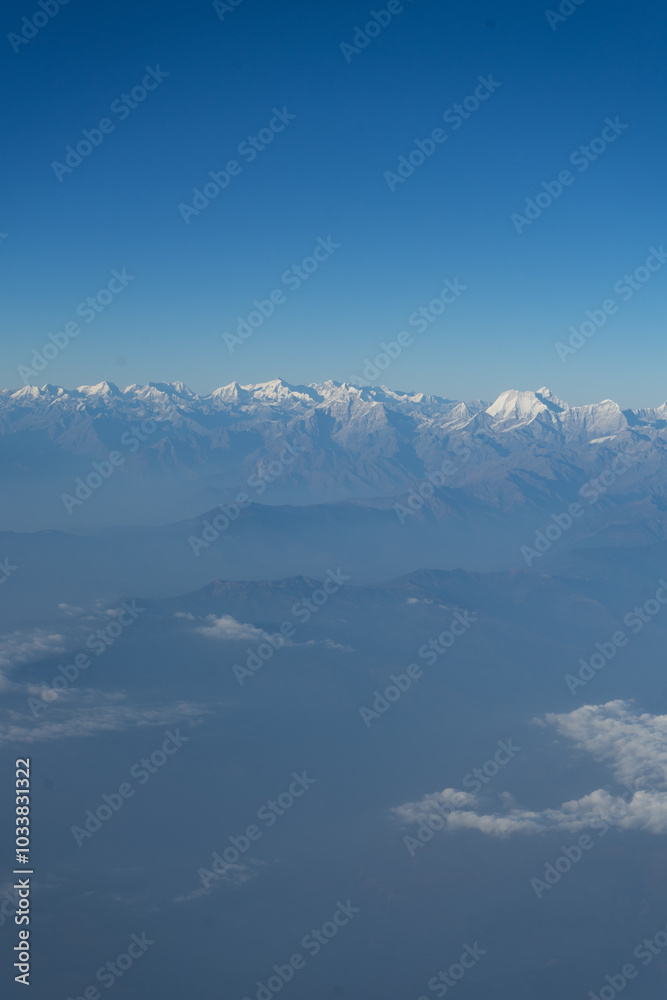 A stunning view of snow-capped mountains under a clear blue sky. A stunning view of snow-capped mountains under a clear blue sky.