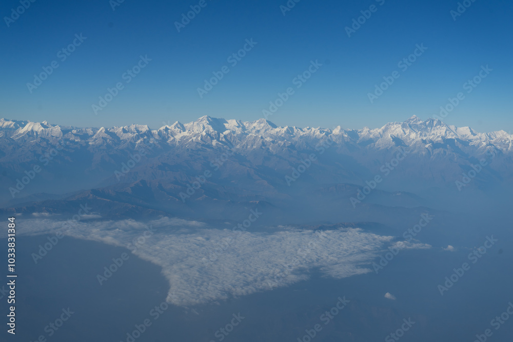A breathtaking view of the snow-capped mountain range under a clear blue sky. A breathtaking view of the snow-capped mountain range under a clear blue sky.