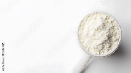 Sports nutrition. Scoop of protein near shaker on white background top view copy space. 