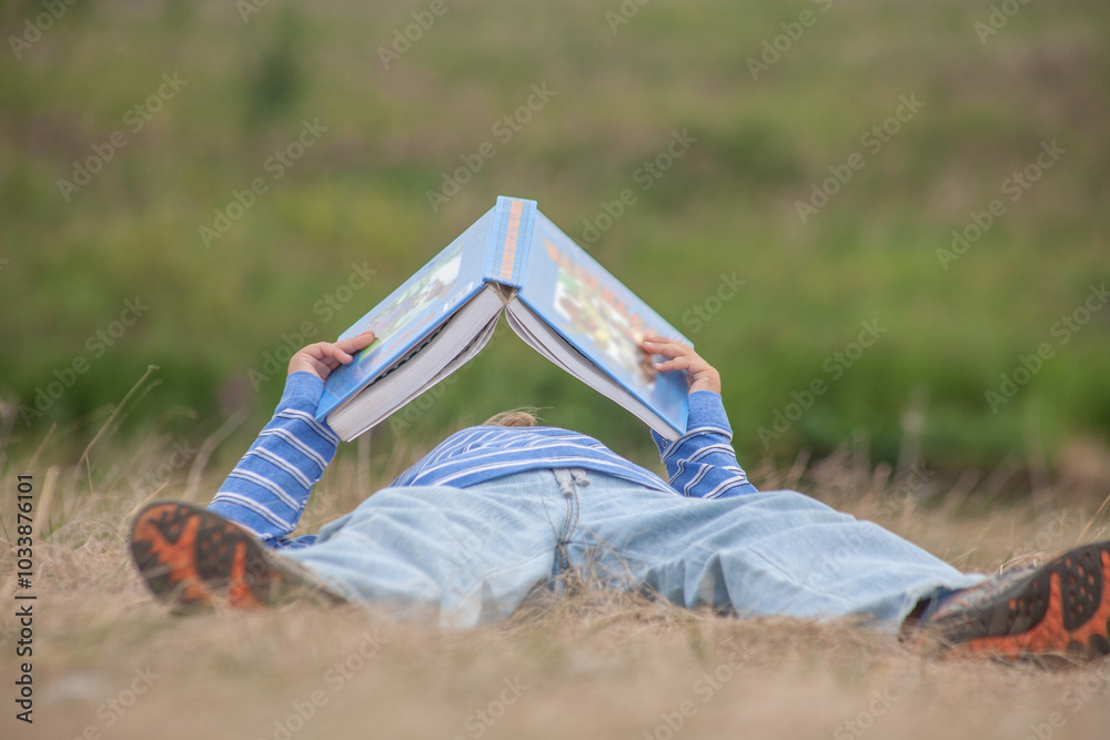 little boy reading book