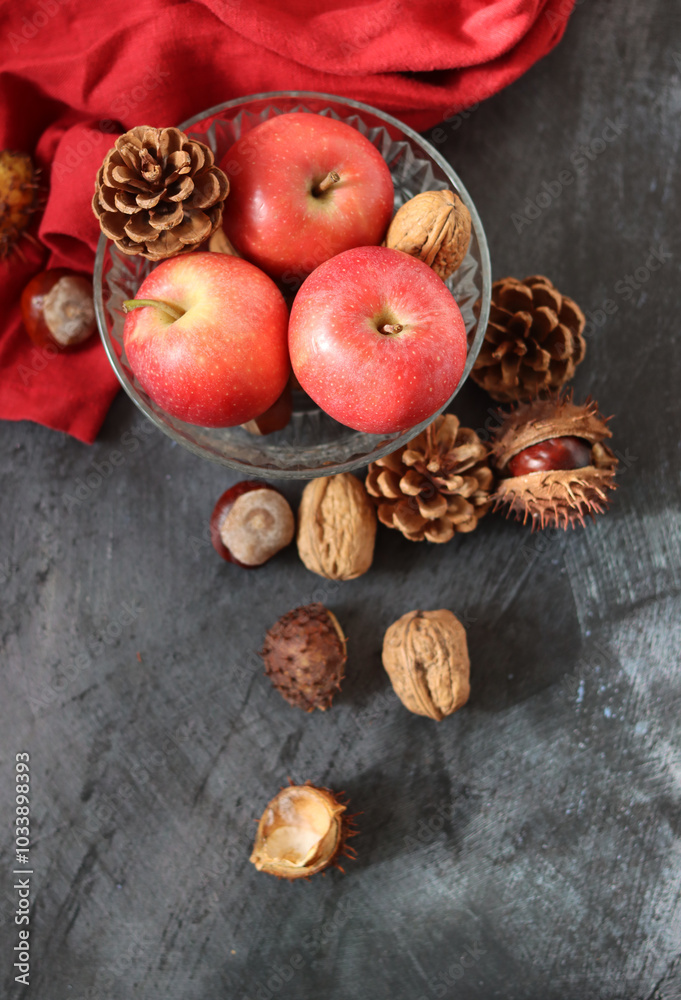 Autumn still life with apples, chestnuts and pine cones on dark background with space for text. Autumn still life with apples, chestnuts and pine cones on dark background with space for text.