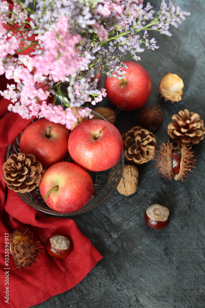 Autumn still life with apples, chestnuts and pine cones on dark background with space for text. Autumn still life with apples, chestnuts and pine cones on dark background with space for text.