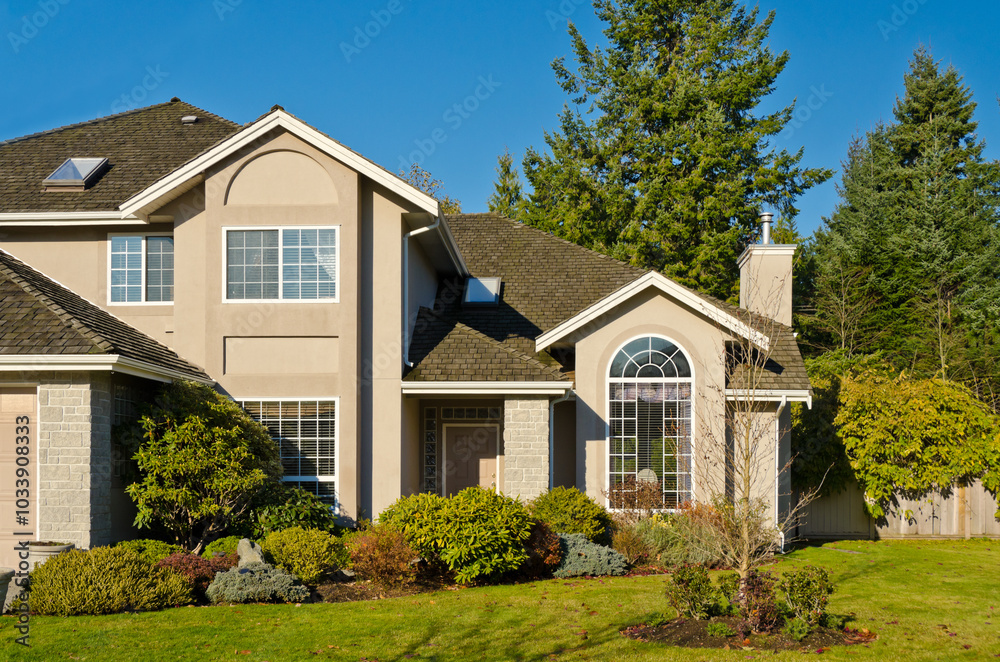 luxury house with garage door, big tree and nice Fall Foliage landscape in Vancouver, Canada