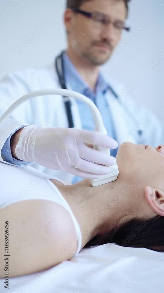 Doctor man wearing white protective gloves is using ultrasound machine to examine neck of female patient in hospital. Medicine, thyroid gland health Doctor man wearing white protective gloves is using ultrasound machine to examine neck of female patient in hospital. Medicine, thyroid gland health