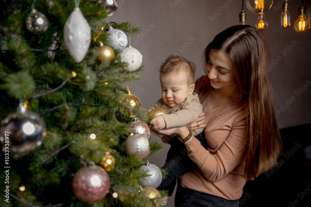 Mother holding her baby, both admiring christmas decorations. warm lighting from vintage bulbs creates cozy holiday atmosphere, enhancing festive spirit. Mother holding her baby, both admiring christmas decorations. warm lighting from vintage bulbs creates cozy holiday atmosphere, enhancing festive spirit.