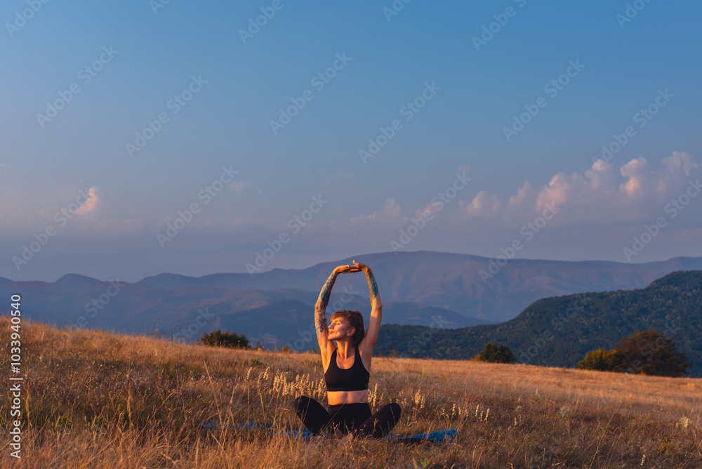 Woman Stretching Hands on Yoga Mat Outdoors