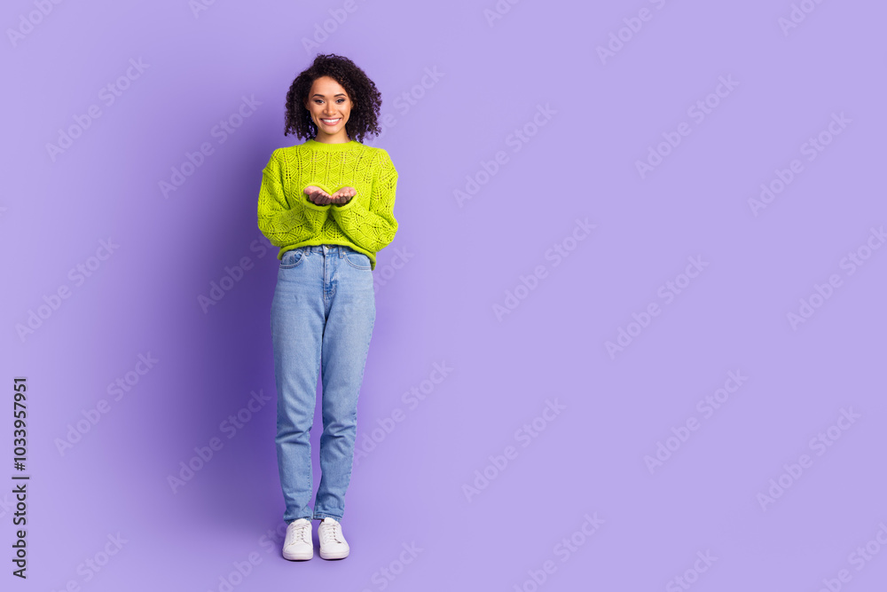 Full length photo of lovely young lady hold empty space dressed stylish green garment isolated on violet color background