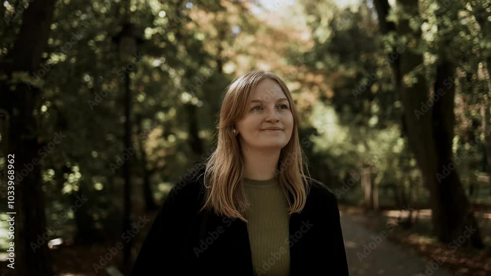 Attractive Caucasian 30s woman walking down the park looking at the camera. Happy relaxed lady walking on the autumn park enjoying. High quality FullHD footage Attractive Caucasian 30s woman walking down the park looking at the camera. Happy relaxed lady walking on the autumn park enjoying. High quality FullHD footage