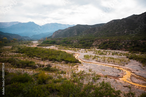 Hermosa vista del Río de Dos colores en la localidad de Chilecito, provincia de La Rioja, en Argentina, donde se puede apreciar una mezcla de colores cobrizos y grises entre rocas y montañas. photo