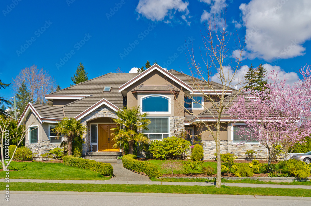 Two story stucco luxury house with nice spring blossom landscape in Vancouver, Canada Two story stucco luxury house with nice spring blossom landscape in Vancouver, Canada