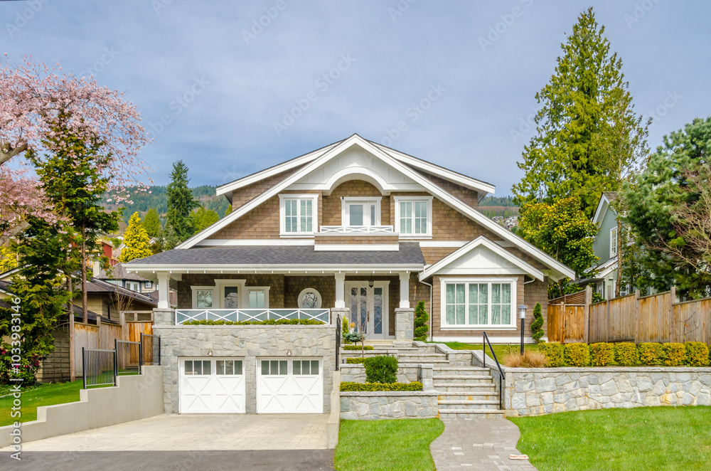 Two story stucco luxury house with nice spring blossom landscape in Vancouver, Canada Two story stucco luxury house with nice spring blossom landscape in Vancouver, Canada