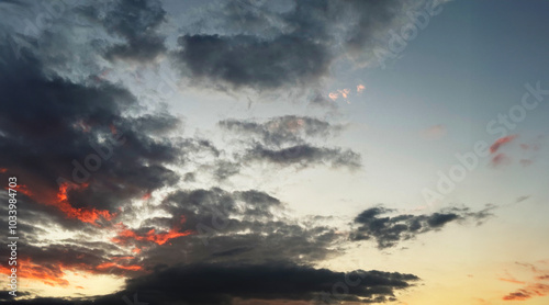 Dramatic Colorful Sunset Sky. Clouds with Sunrays. Cloudscape Sunset Background. Panorama Sky. Dramatic sky with clouds at sunset or sunrise. Sunset Sundown. Sky with colorful clouds.