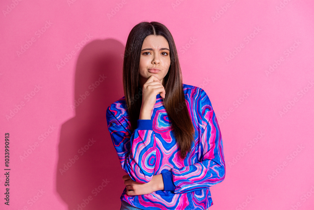 Photo portrait of pretty teen girl thoughtful skeptical wear trendy colorful outfit isolated on pink color background Photo portrait of pretty teen girl thoughtful skeptical wear trendy colorful outfit isolated on pink color background